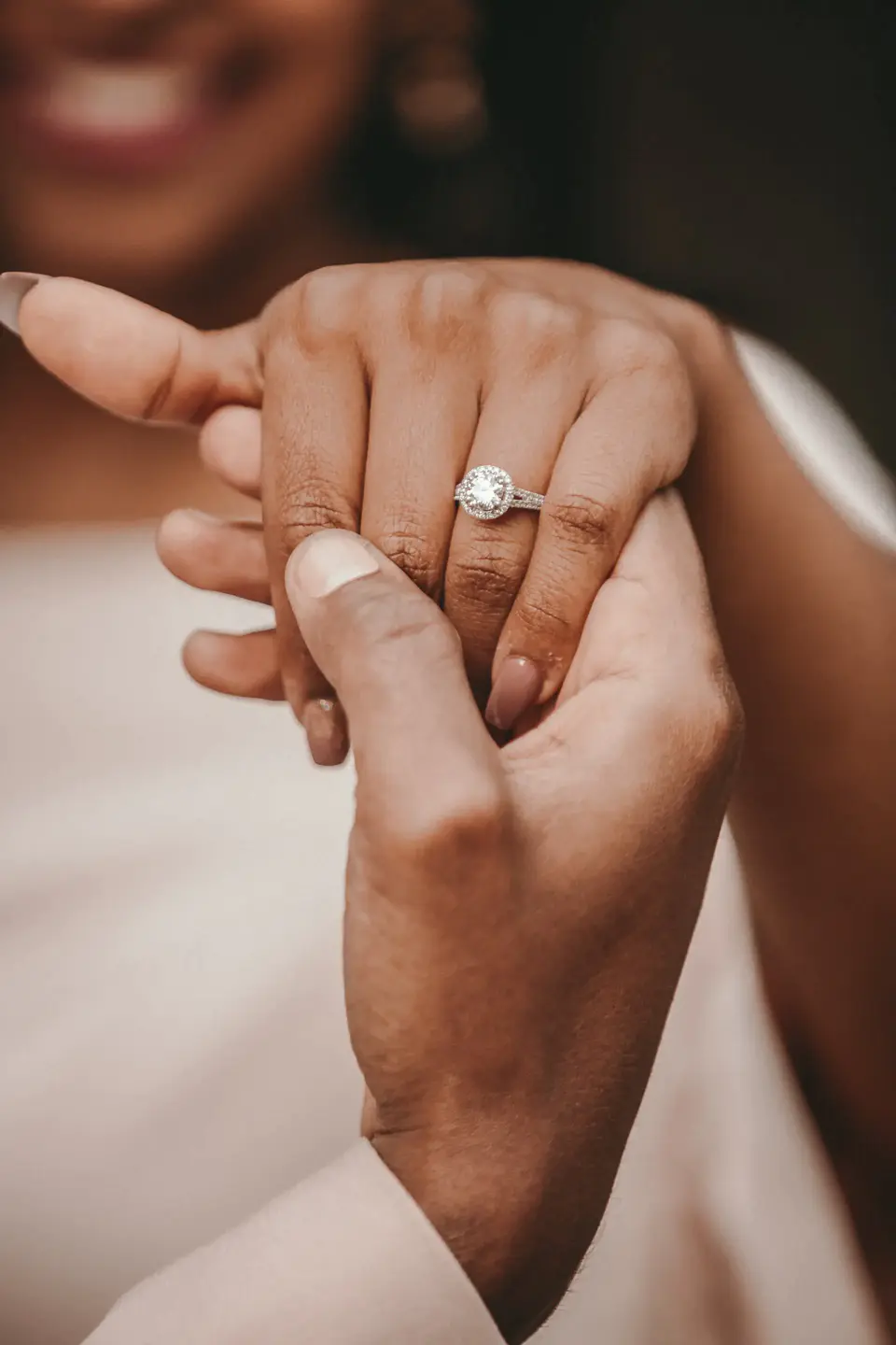 Close-up of an engagement ring on a bride's finger, showcasing the fine jewelry selection from The Luxury List in New York City, a testament to the city's elegance.